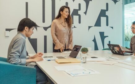 Diverse group of professionals collaborating during a meeting, sharing ideas and reviewing documents